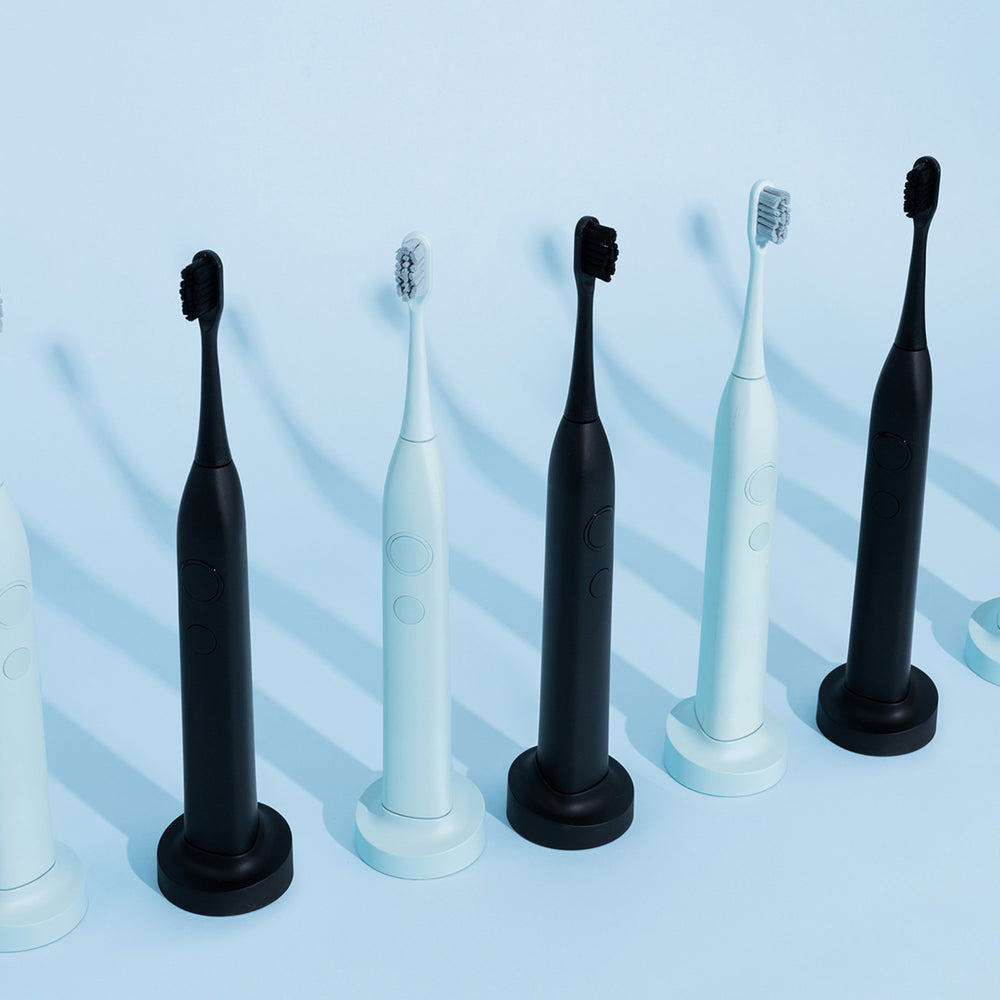 SmilePro Sonic Toothbrushes in Soft Mint and Satin Black standing in a row